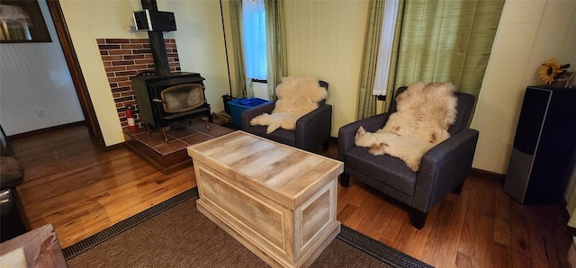 22 Ballard St, Smallwood, NY 12778 - sitting room with wood finished floors, baseboards, and a wood stove