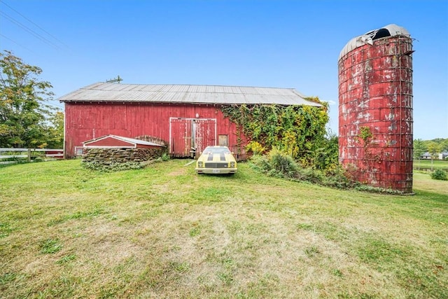 view of barn with a lawn