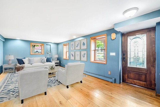 living room featuring wood-type flooring and a baseboard radiator