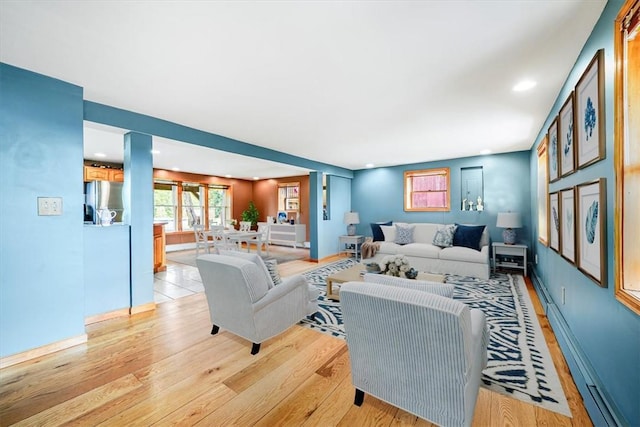 living area with baseboards and light wood-style flooring