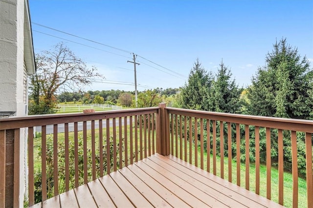 wooden terrace featuring a yard