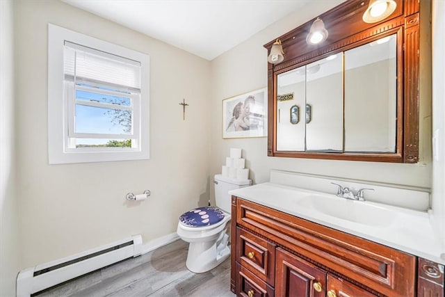 bathroom featuring a baseboard radiator, baseboards, toilet, wood finished floors, and vanity