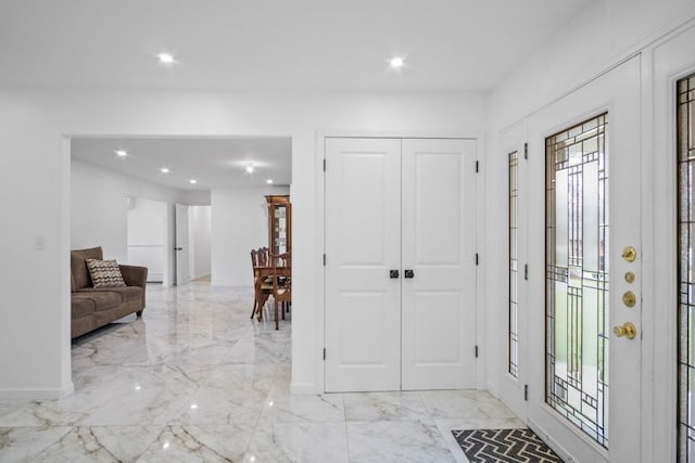 entrance foyer with baseboards, marble finish floor, and recessed lighting