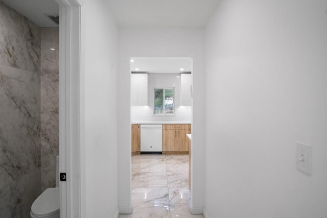 corridor featuring marble finish floor