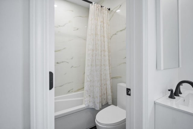 bathroom featuring shower / tub combo and toilet