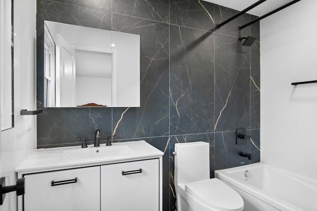 full bath with decorative backsplash, vanity, tile walls, toilet, and bathing tub / shower combination