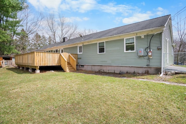 back of property with stairway, a lawn, and a deck