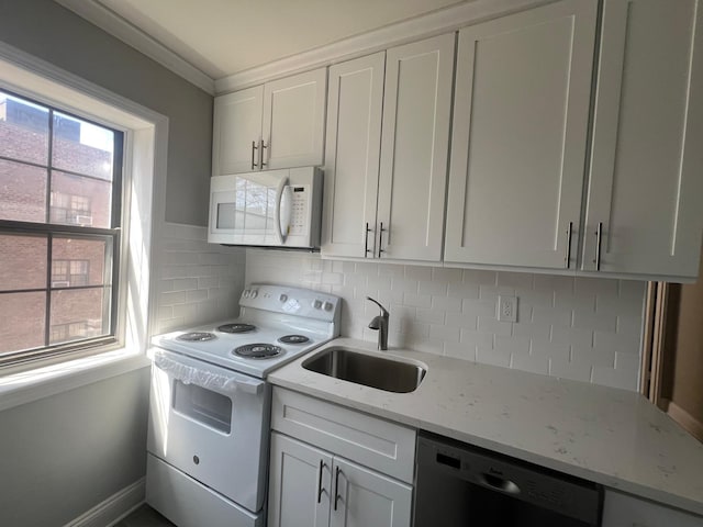 144-32 78th Ave Unit 3F, Flushing, NY 11367 - kitchen featuring white appliances, a sink, white cabinetry, and light stone counters