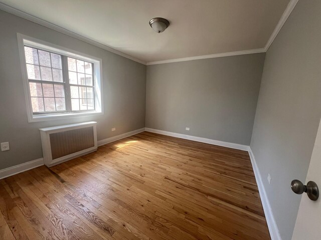 144-32 78th Ave Unit 3F, Flushing, NY 11367 - unfurnished room with radiator, wood finished floors, baseboards, and ornamental molding