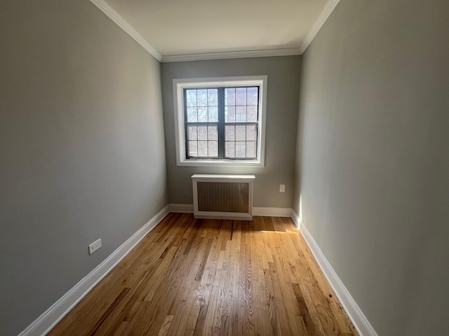 144-32 78th Ave Unit 3F, Flushing, NY 11367 - unfurnished room with radiator heating unit, wood finished floors, ornamental molding, and baseboards