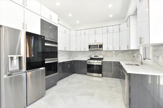 76-47 173rd St, Fresh Meadows, NY 11366 - kitchen featuring light stone countertops, tasteful backsplash, white cabinets, a sink, and stainless steel appliances