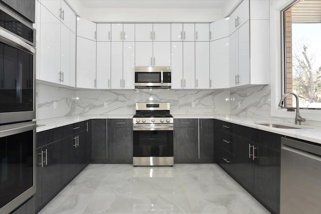 76-47 173rd St, Fresh Meadows, NY 11366 - kitchen featuring a sink, tasteful backsplash, white cabinets, and appliances with stainless steel finishes