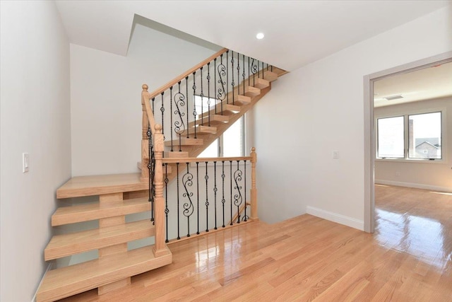76-47 173rd St, Fresh Meadows, NY 11366 - staircase with recessed lighting, wood finished floors, and baseboards