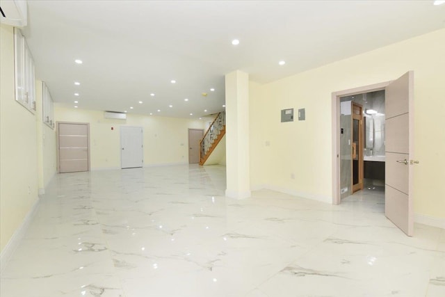 76-47 173rd St, Fresh Meadows, NY 11366 - spare room featuring baseboards, an AC wall unit, recessed lighting, stairway, and marble finish floor