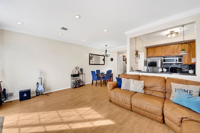 living area featuring visible vents, recessed lighting, light wood-style floors, and a notable chandelier