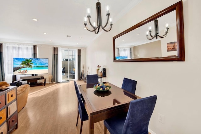 dining space with crown molding, recessed lighting, a notable chandelier, and light wood finished floors