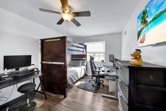 bedroom with visible vents, a ceiling fan, and wood finished floors