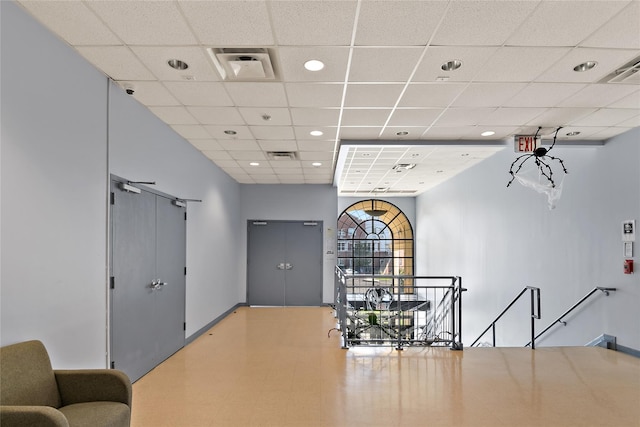 corridor featuring recessed lighting, an upstairs landing, a paneled ceiling, and visible vents