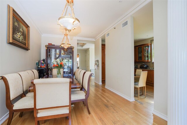 2314 National Dr, Brooklyn, NY 11234 - dining room with baseboards, visible vents, crown molding, and light wood-style floors