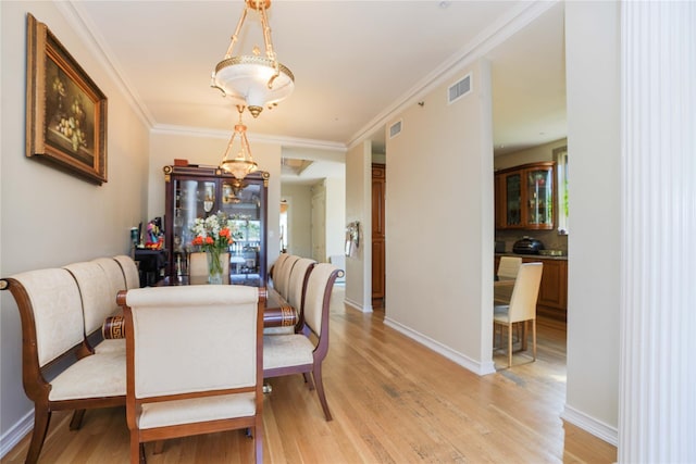 2314 National Dr, Brooklyn, NY 11234 - dining area with baseboards, visible vents, crown molding, and light wood-style flooring