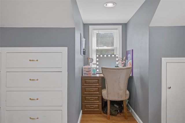 home office with baseboards and light wood finished floors