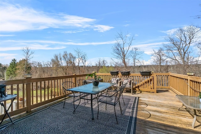 wooden deck featuring outdoor dining space