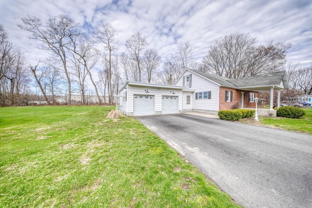 view of front of home featuring a garage, a front yard, and aphalt driveway