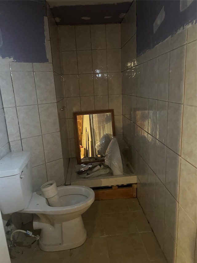 bathroom featuring tile walls, toilet, and tile patterned flooring