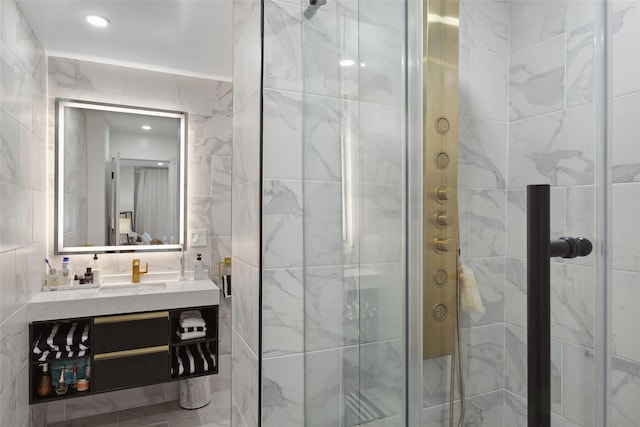 bathroom featuring recessed lighting, a shower stall, tile walls, and vanity