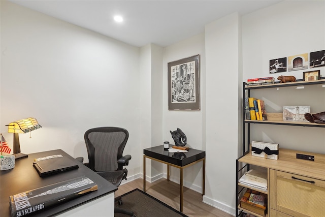 office space featuring baseboards, wood finished floors, and recessed lighting