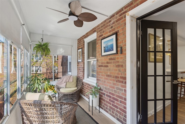 sunroom with a ceiling fan