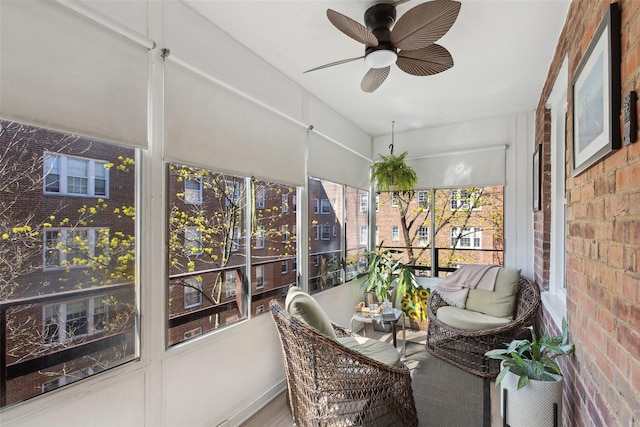 sunroom / solarium featuring ceiling fan