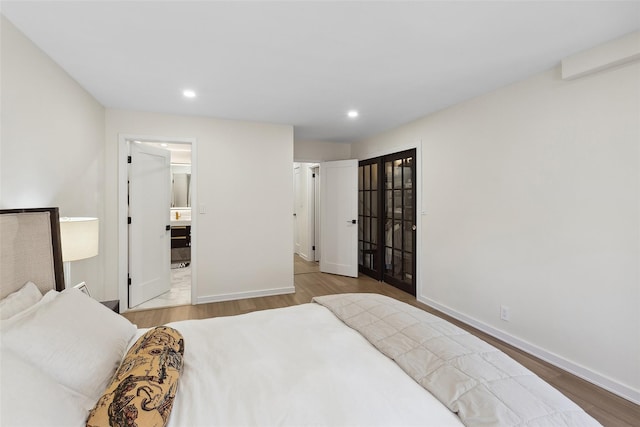bedroom featuring recessed lighting, wood finished floors, and baseboards