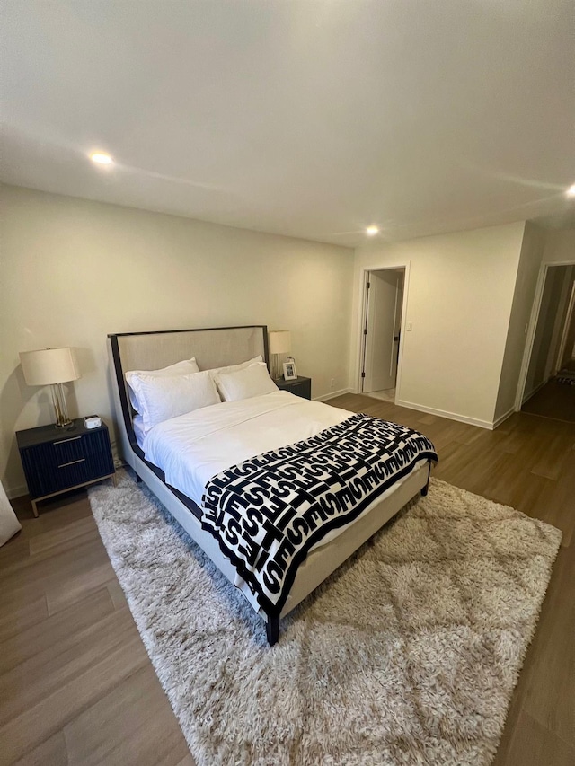 bedroom featuring recessed lighting, baseboards, and wood finished floors