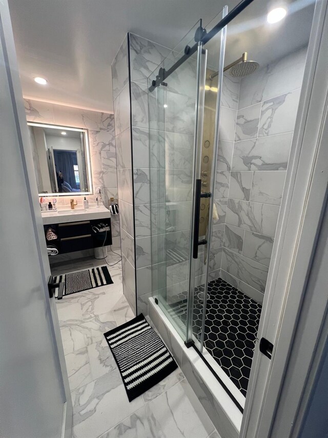 bathroom featuring a stall shower, marble finish floor, vanity, and recessed lighting