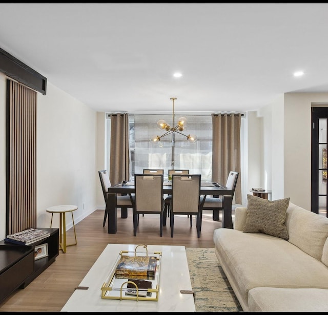 living area featuring wood finished floors, recessed lighting, and a notable chandelier