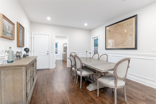 dining space featuring wainscoting, recessed lighting, a decorative wall, and dark wood-type flooring
