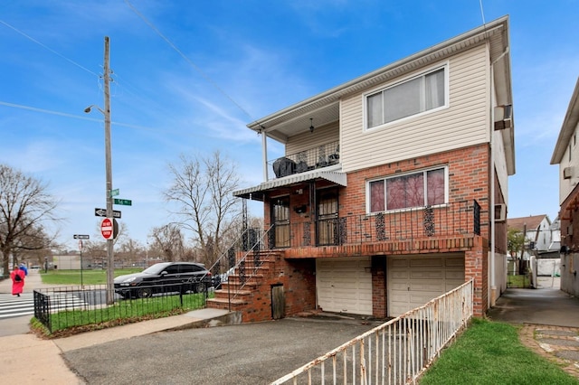 54-30 Kissena Blvd, Flushing, NY 11355 - rear view of house with fence, a balcony, aphalt driveway, brick siding, and a garage