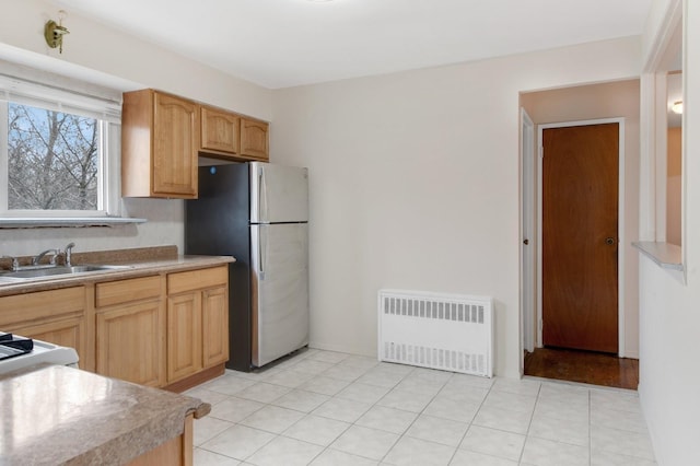 54-30 Kissena Blvd, Flushing, NY 11355 - kitchen with light countertops, a sink, radiator, light tile patterned floors, and freestanding refrigerator