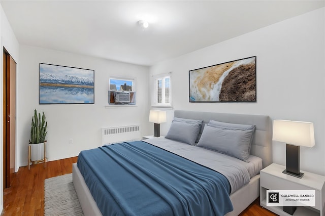 54-30 Kissena Blvd, Flushing, NY 11355 - bedroom with cooling unit, radiator, and wood finished floors