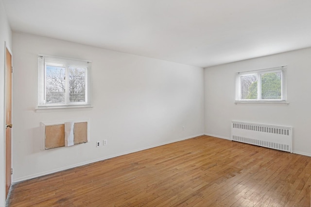 54-30 Kissena Blvd, Flushing, NY 11355 - empty room with baseboards, radiator heating unit, and hardwood / wood-style flooring