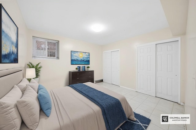 54-30 Kissena Blvd, Flushing, NY 11355 - bedroom featuring light tile patterned flooring, baseboards, and two closets