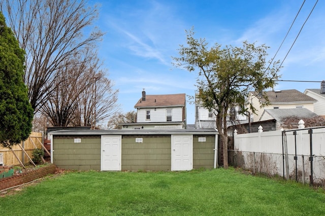 54-30 Kissena Blvd, Flushing, NY 11355 - back of property featuring an outdoor structure, fence, a yard, and a chimney