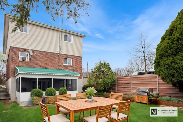 54-30 Kissena Blvd, Flushing, NY 11355 - back of house with a sunroom, fence, outdoor dining space, brick siding, and a lawn