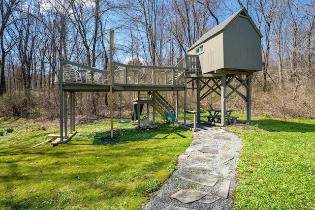 view of yard with a wooden deck and a playground