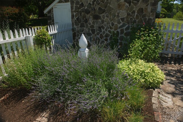 details featuring stone siding and fence