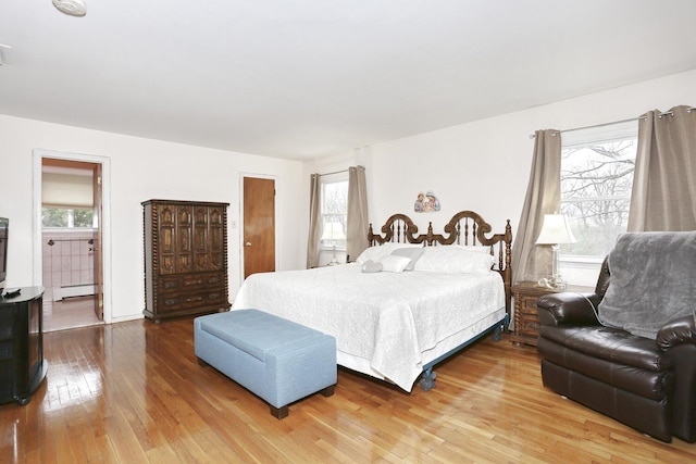 106 Key Pl, Orangeburg, NY 10962 - bedroom with wood-type flooring, a baseboard radiator, and multiple windows