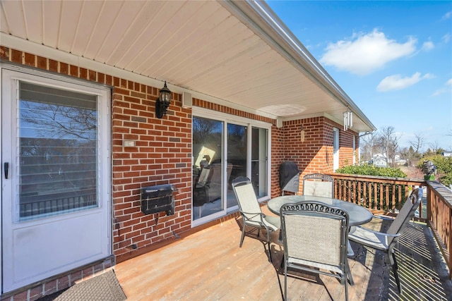 wooden terrace with outdoor dining area