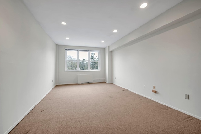 unfurnished room featuring baseboards, recessed lighting, and light colored carpet