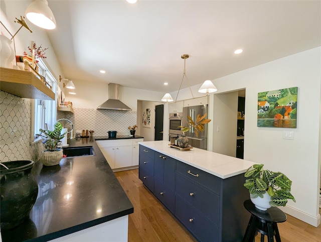 1 Concord Dr, Fort Salonga, NY 11768 - kitchen with wall chimney exhaust hood, stainless steel refrigerator, a sink, light wood finished floors, and tasteful backsplash